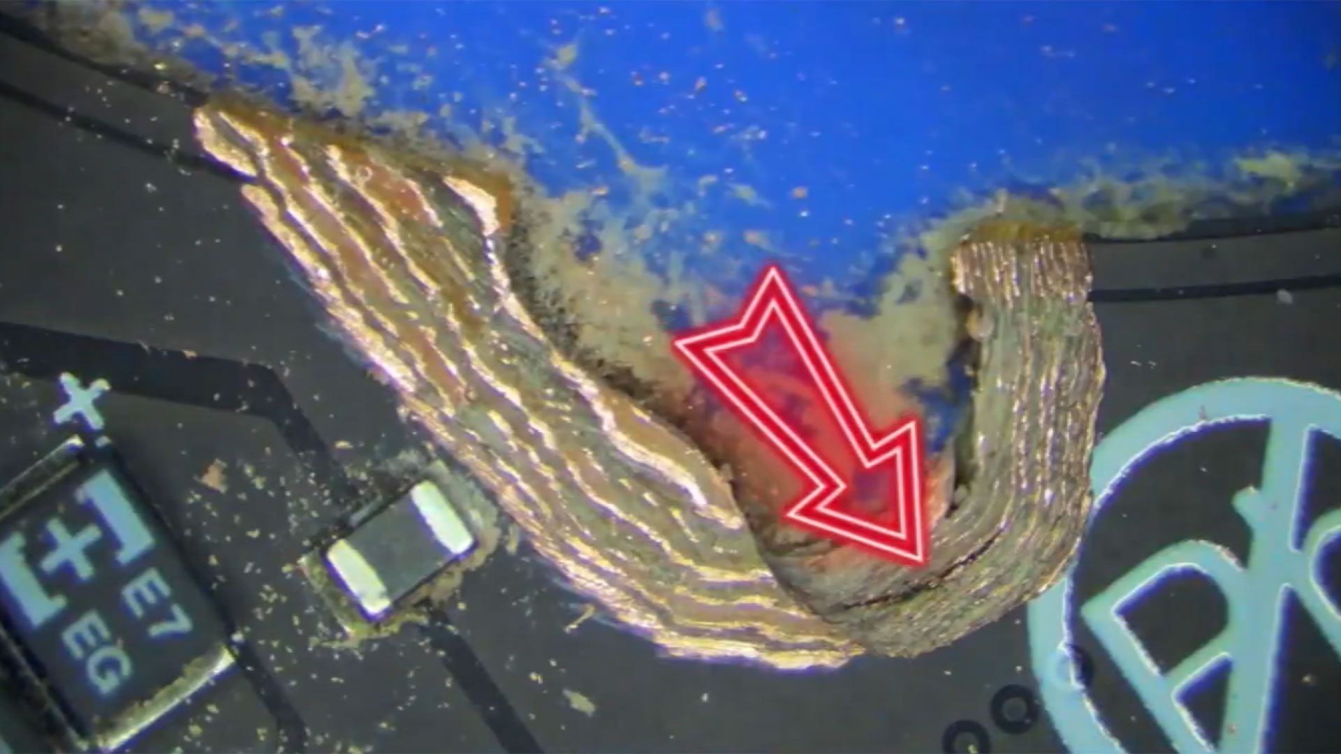 Razer laptop motherboard repair video showcases superhuman hand-soldering skills — PCB damage appears to be the result of a misplaced screw hole on a motherboar