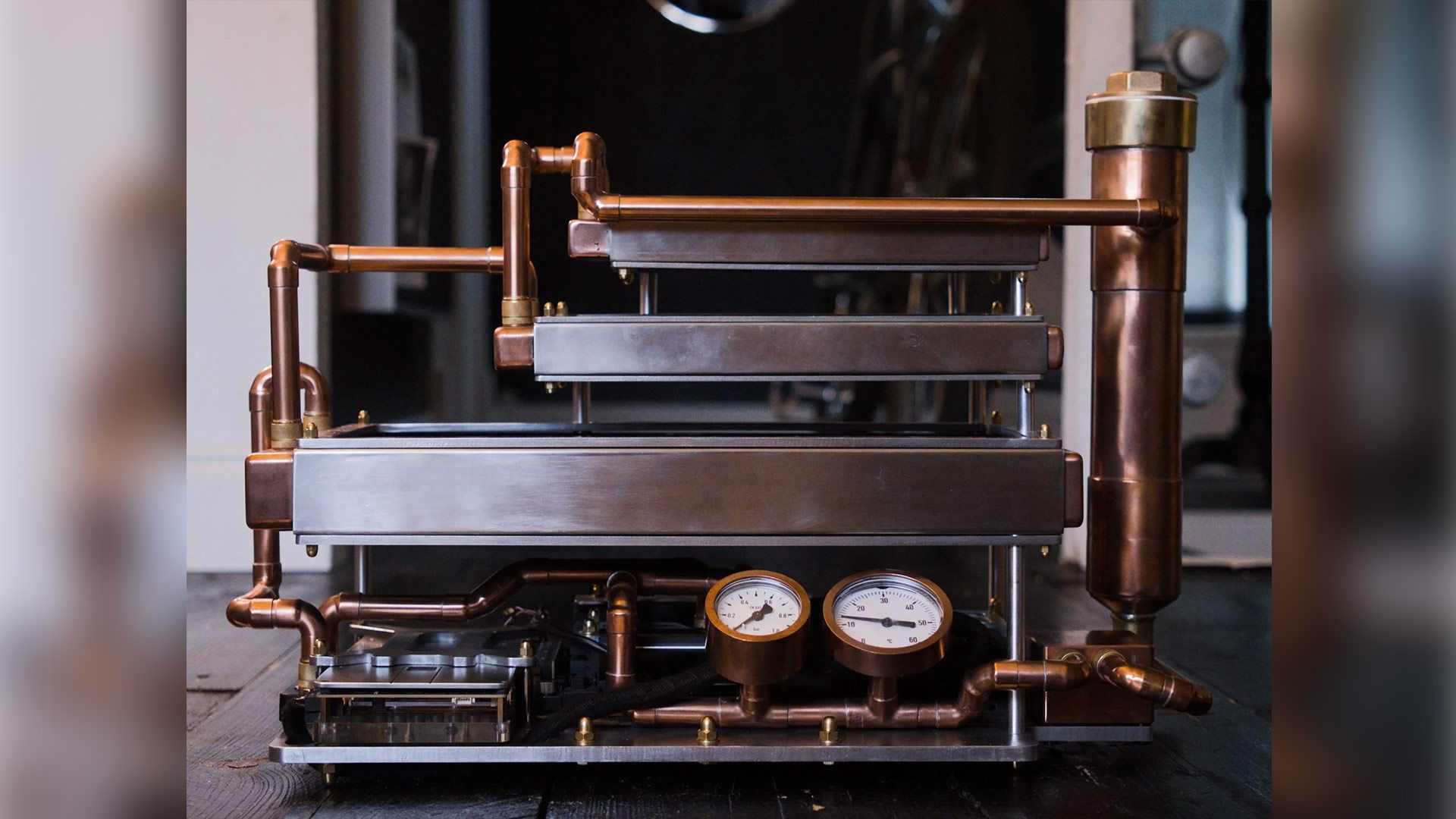 Custom-built passive water-cooled PC relies on convection chimney effect powered by triple-stacked radiators — 9800X3D build with RTX 5080 has no fans, copper, 